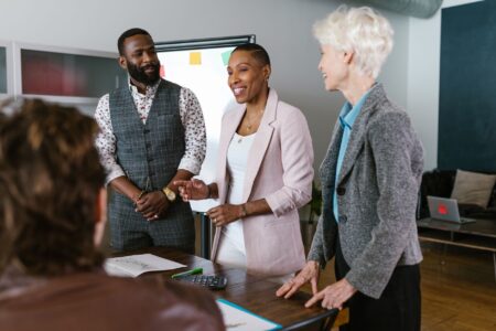 Secondhand Private Equity Stakes Quietly Find Buyers on Secondary Markets Business professionals reviewing investment documents at a conference table