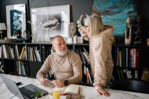 Longevity-Linked Annuities Quietly Attract Aging Allocators as Lifespans Extend Older couple reviewing financial documents at a table, planning for retirement
