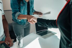 Mezzanine Debt Funds Quietly Absorb Mid-Market Capital as Banks Retreat Two professionals shaking hands across a conference table during a corporate financing meeting