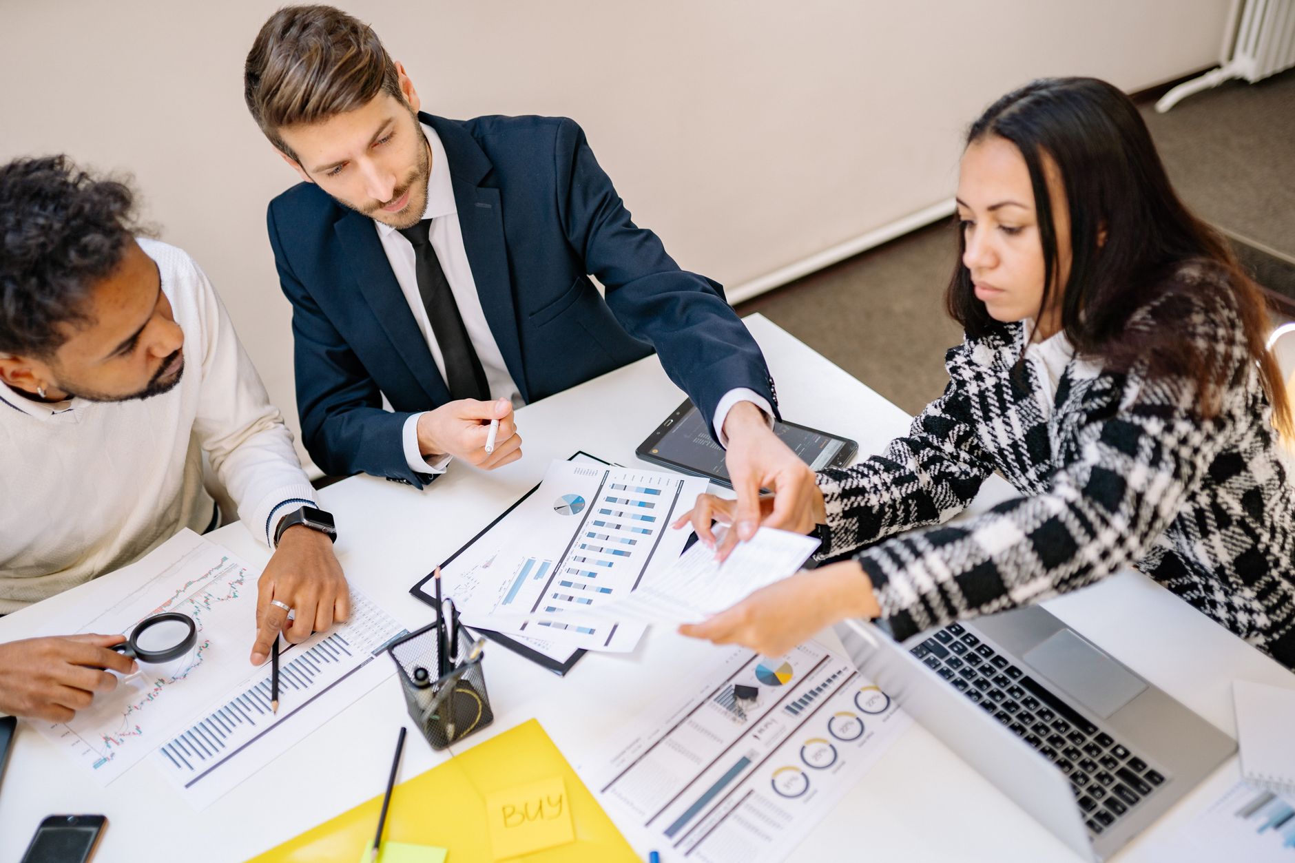 Business professionals reviewing financial documents in a private office setting