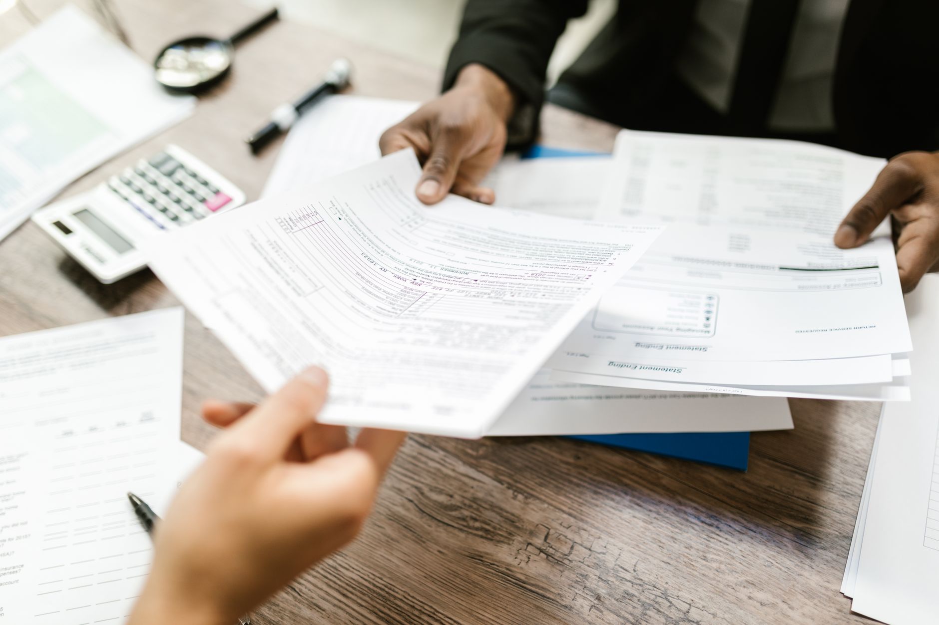 Tax documents and financial papers spread across a desk