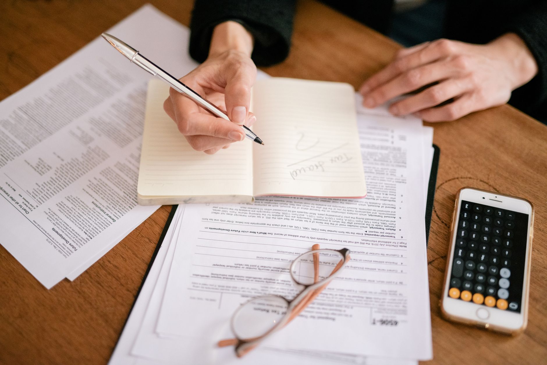 Tax forms and financial statements on a desk illustrating tax-exempt investment calculations