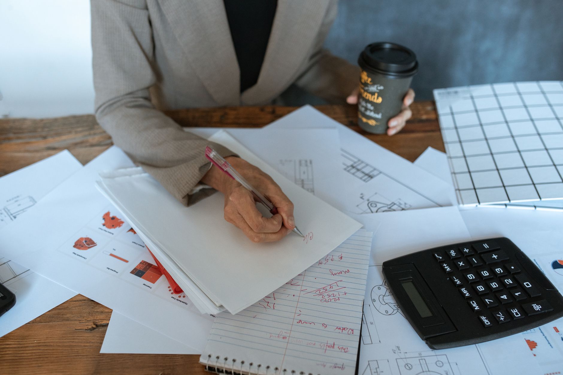 Financial analyst reviewing investment fund documents at a desk