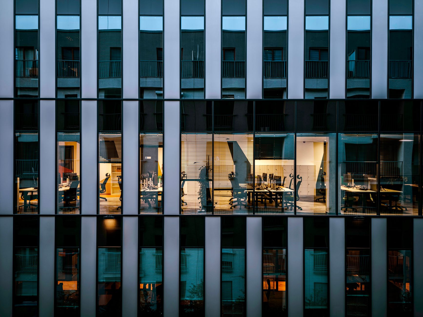 Institutional investment office with analysts reviewing portfolio strategy documents