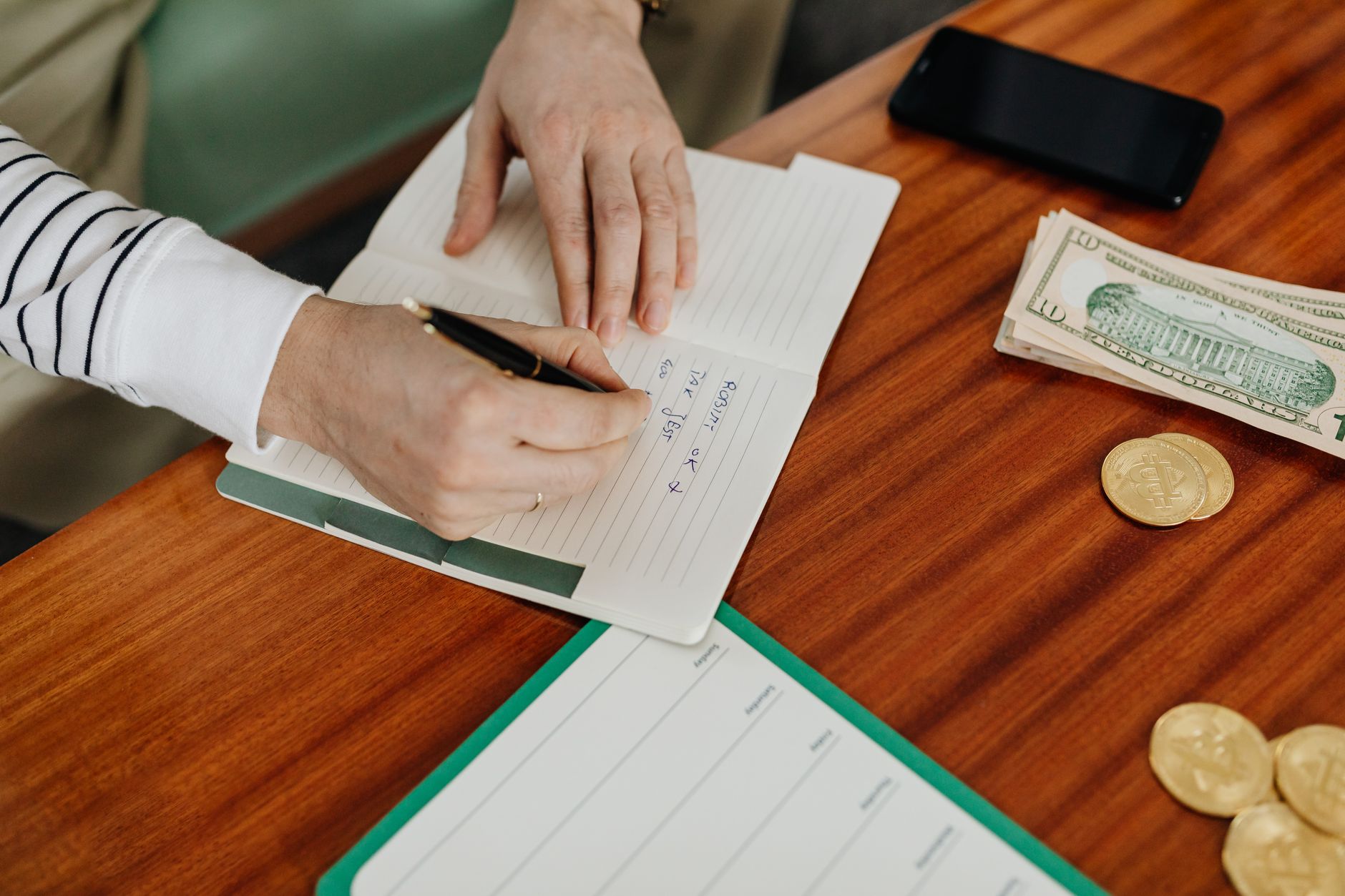 A notebook with retirement income planning notes next to a calculator and pen