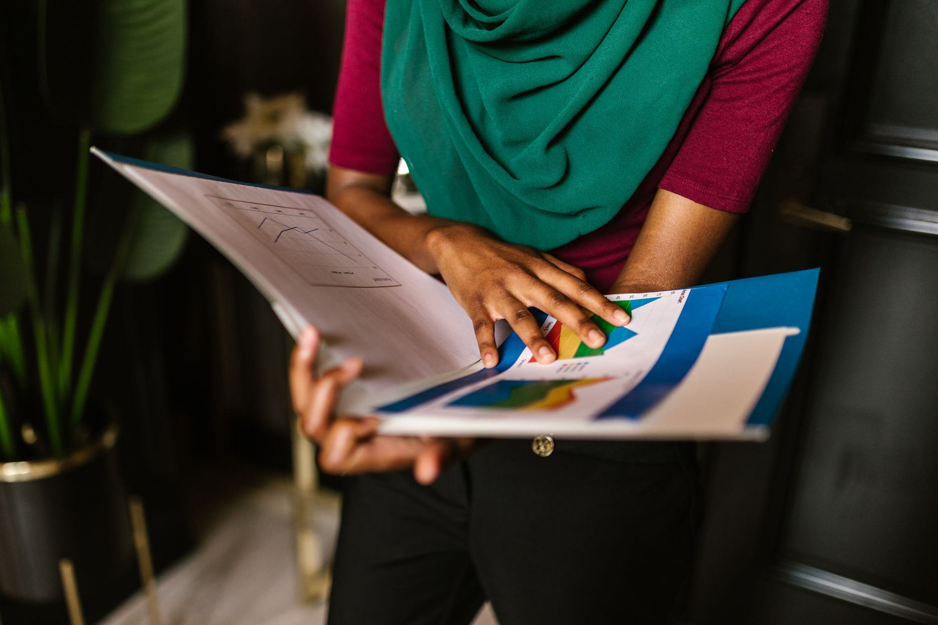 Investor reviewing financial portfolio documents representing royalty contract due diligence