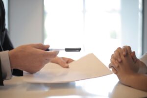 Senior Secured Private Credit Quietly Fills the Middle Market Void Two professionals reviewing loan documents across a conference table, representing middle market lending