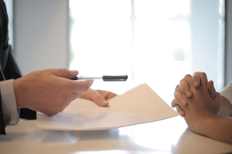 Senior Secured Private Credit Quietly Fills the Middle Market Void Two professionals reviewing loan documents across a conference table, representing middle market lending