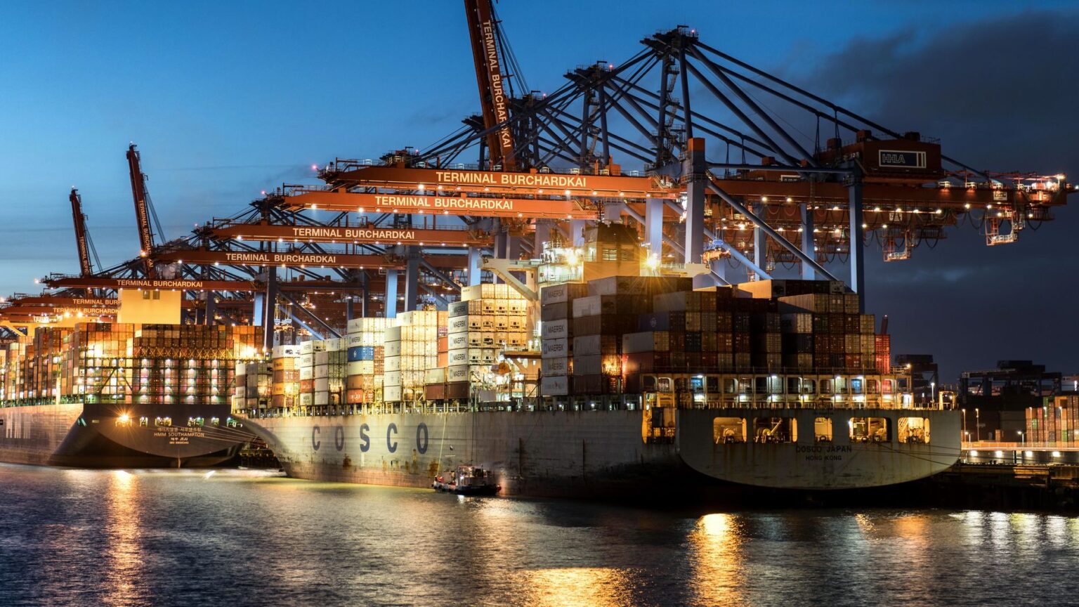 Commodity Trade Finance Funds Quietly Draw Yield-Seeking Allocators Cargo ship docked at a commercial port representing global commodity trade and supply chain financing