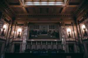 Litigation Finance Funds Quietly Draw Institutional Allocators Seeking Uncorrelated Returns Empty courtroom with wooden benches and judge's bench representing litigation and legal proceedings