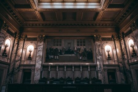 Litigation Finance Funds Quietly Draw Institutional Allocators Seeking Uncorrelated Returns Empty courtroom with wooden benches and judge's bench representing litigation and legal proceedings