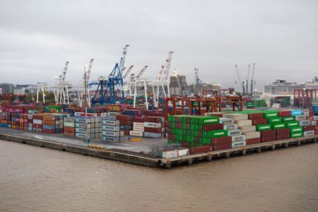 Rows of colorful intermodal shipping containers stacked at a commercial port