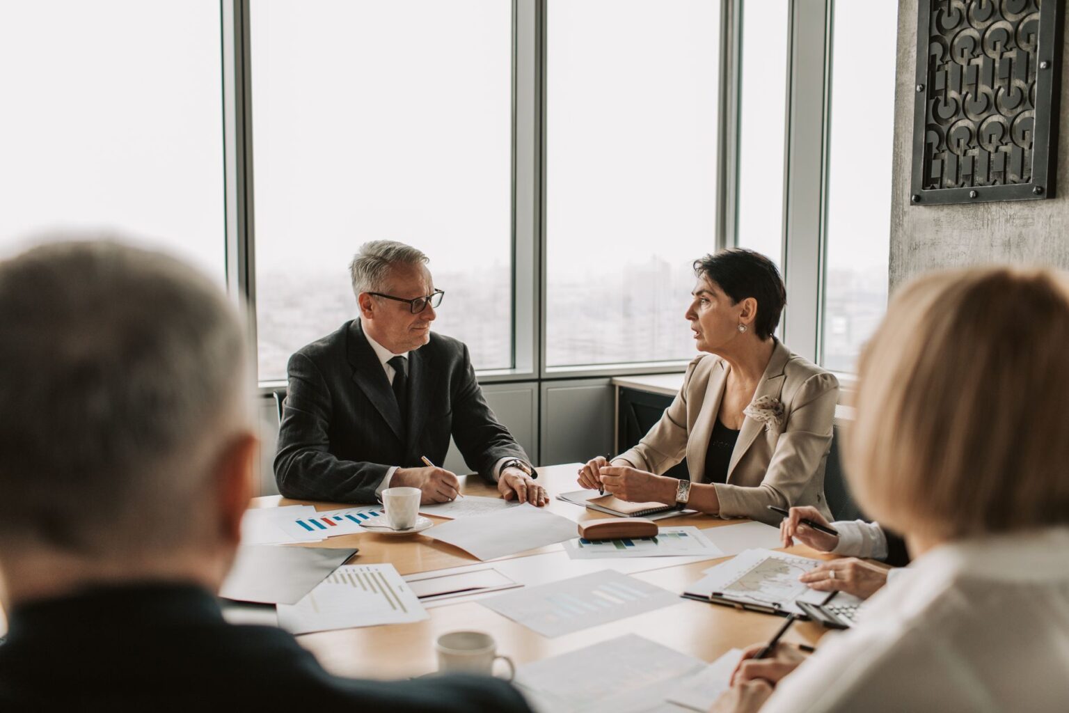 Collateralized Loan Obligation Equity Quietly Tempts Yield-Hungry Family Offices Family office professionals reviewing structured credit investment documents in a boardroom setting