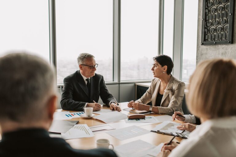Collateralized Loan Obligation Equity Quietly Tempts Yield-Hungry Family Offices Family office professionals reviewing structured credit investment documents in a boardroom setting