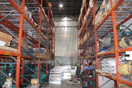 Equipment Leasing Funds Quietly Draw Middle-Market Income Seekers Rows of industrial equipment inside a large warehouse facility