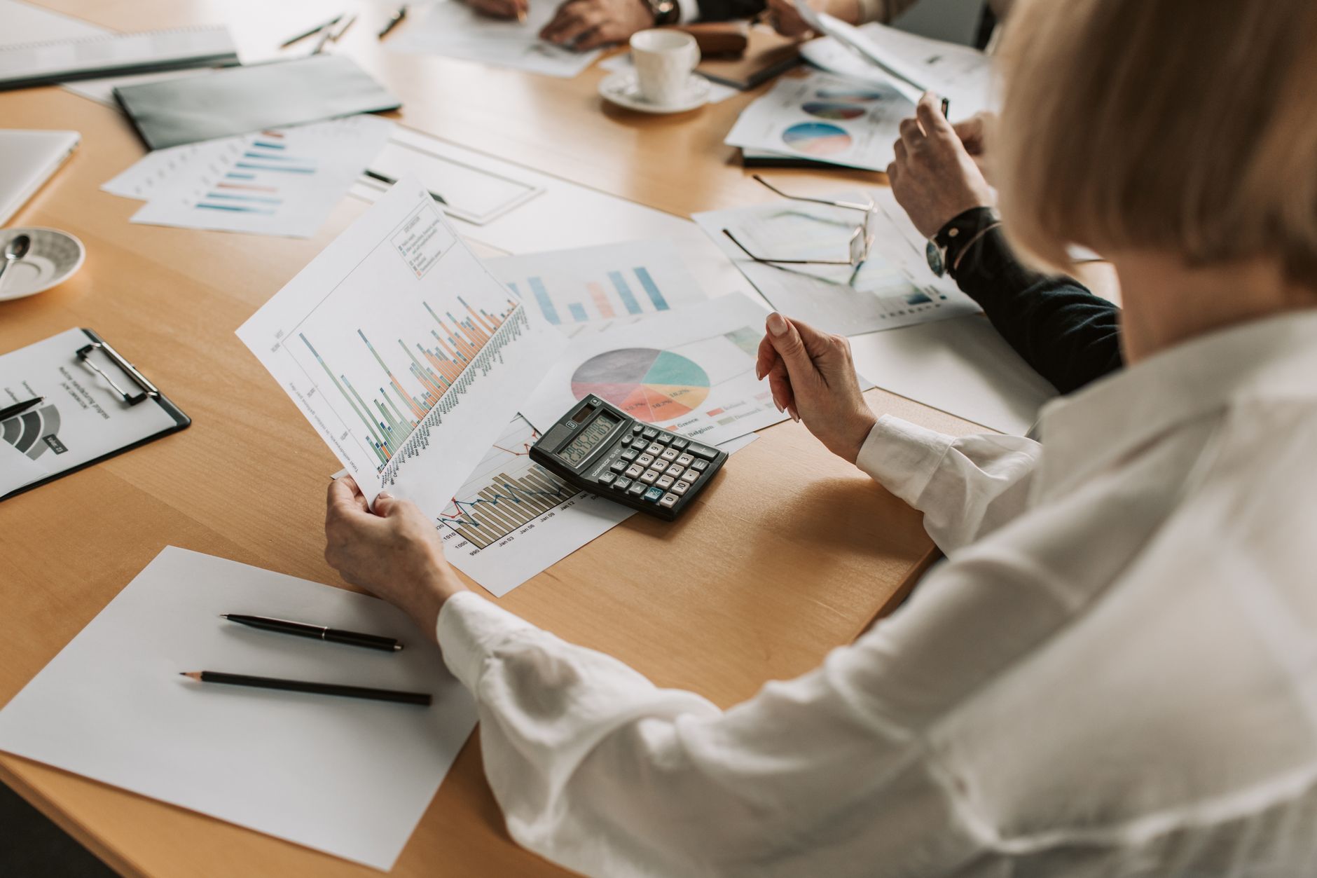 Investors reviewing real estate loan documents at a conference table