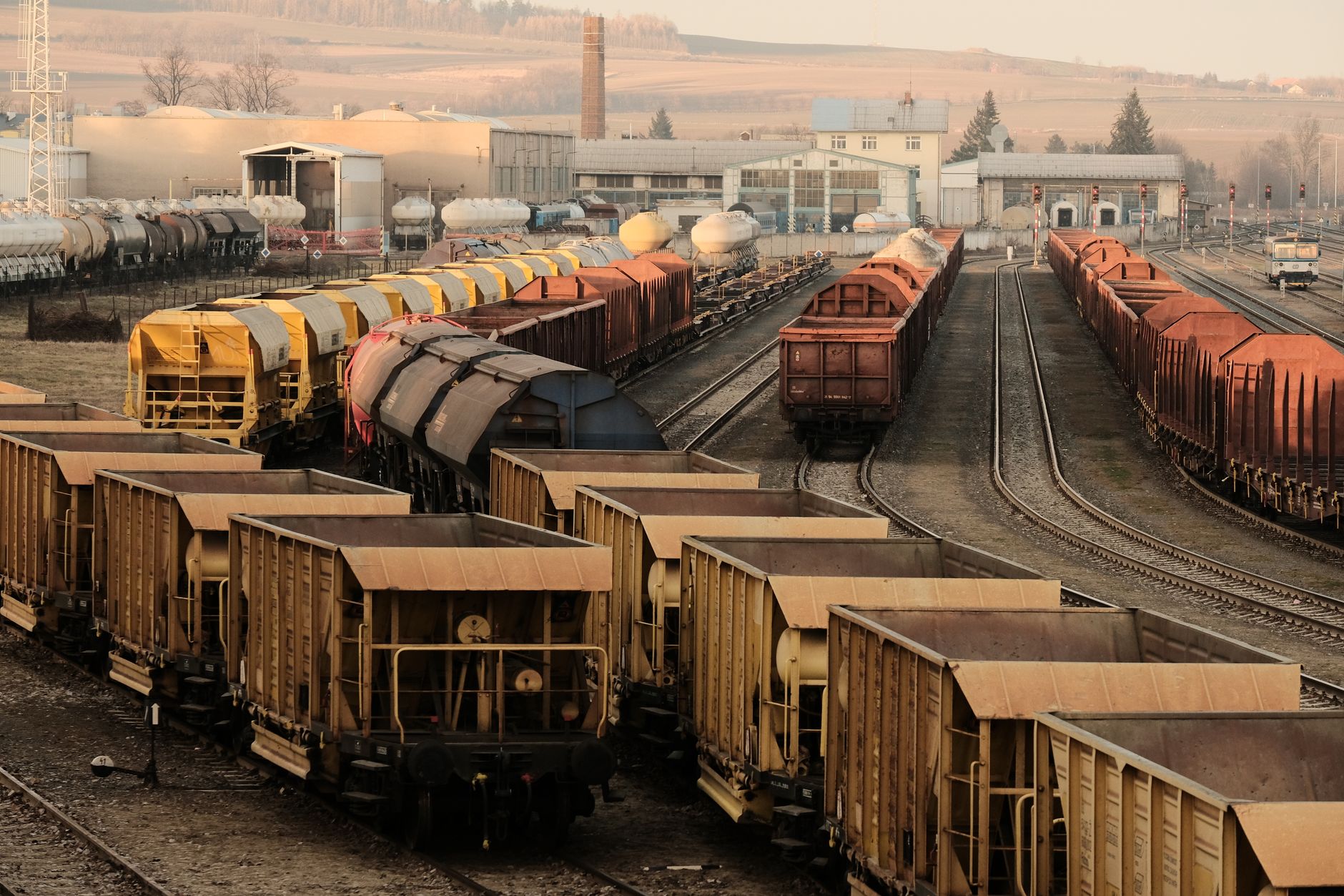 Freight containers being moved by industrial equipment at a logistics facility