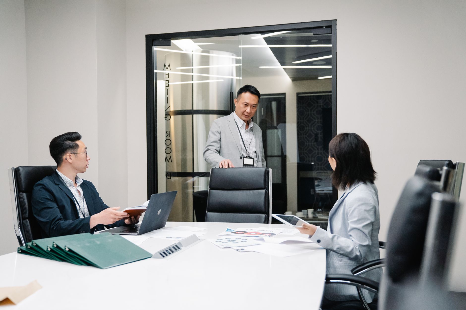 Professional in a wealth management office reviewing a long-term investment portfolio