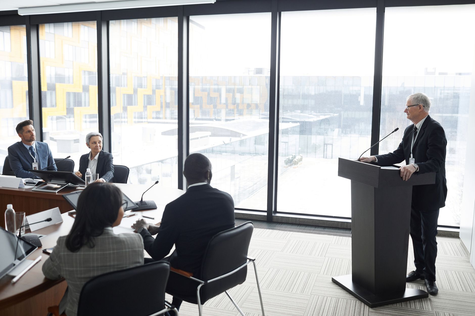 Portfolio managers discussing fixed income allocation strategy in a corporate meeting room